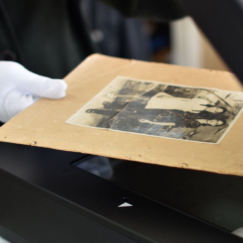 A photo being scanned on our flatbed so it can be restored